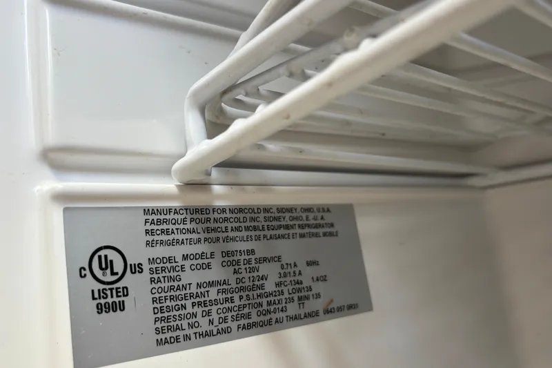 Slide: The Image of Label inside a refrigerator, detailing model DE0751BB, manufactured for Norcold, Inc. - 26
