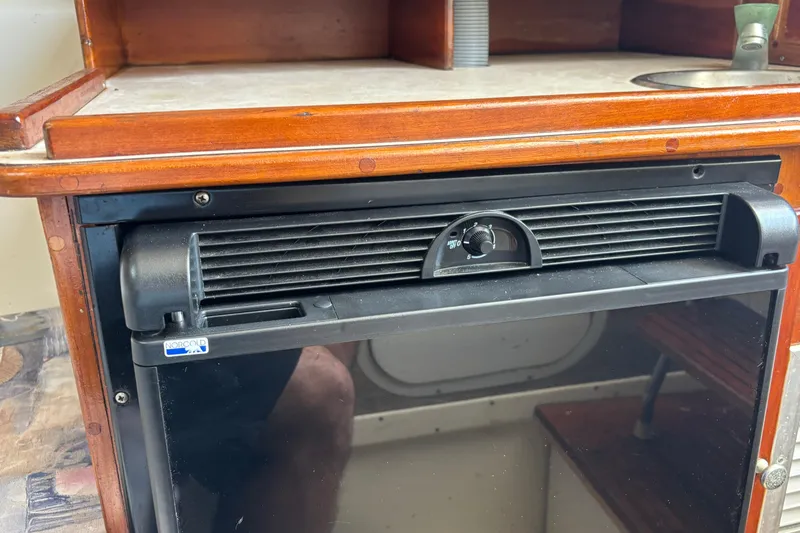 Slide: The Image of Interior of a 2000 Shamrock 260 Express boat featuring a Norcold refrigerator. - 28