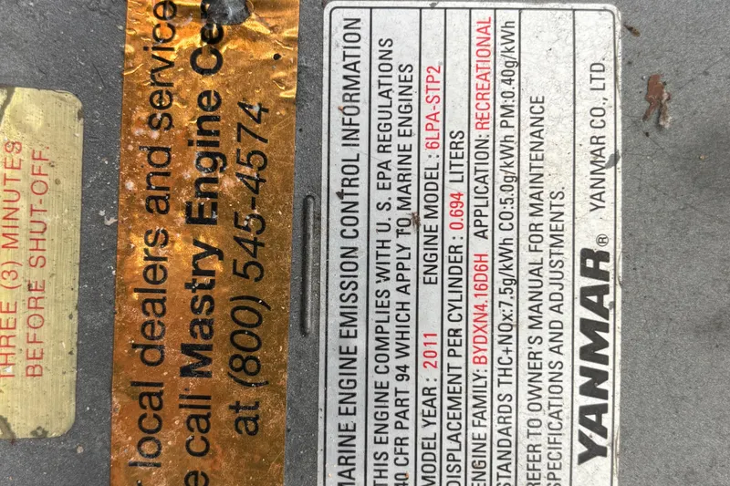 Slide: The Image of Yanmar engine emission control label on Shamrock 260 Express, 2000 model. - 31