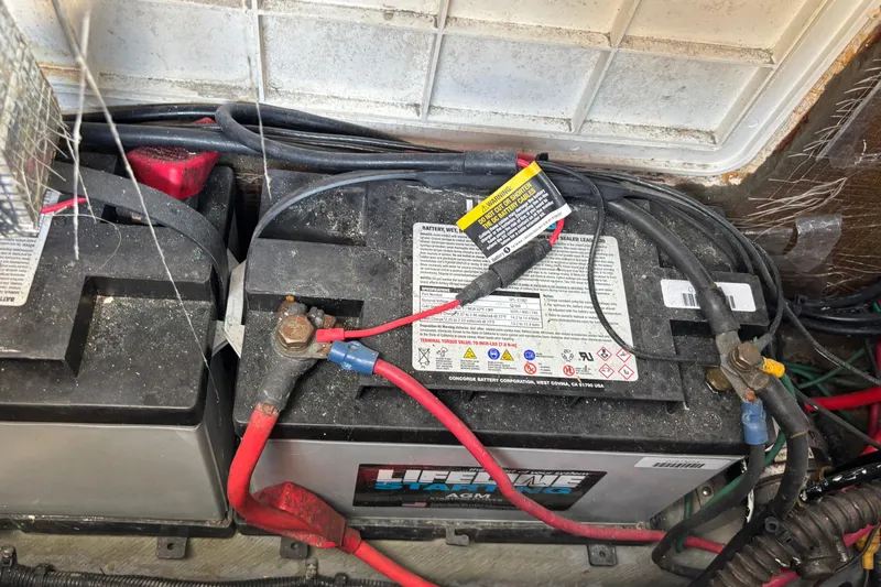 Slide: The Image of Battery compartment of a 2000 Shamrock 260 Express boat with wiring connections. - 33