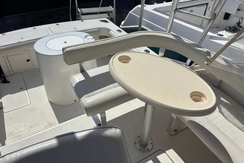 Slide: The Image of Interior of 2000 Shamrock 260 Express boat with seating and table. - 35