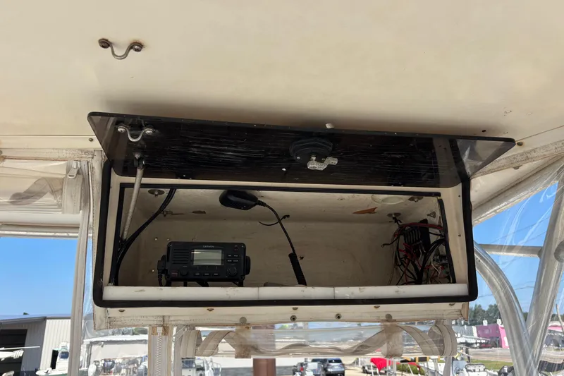 Slide: The Image of Open electronics compartment on 2000 Shamrock 260 Express boat, featuring a Garmin device. - 39