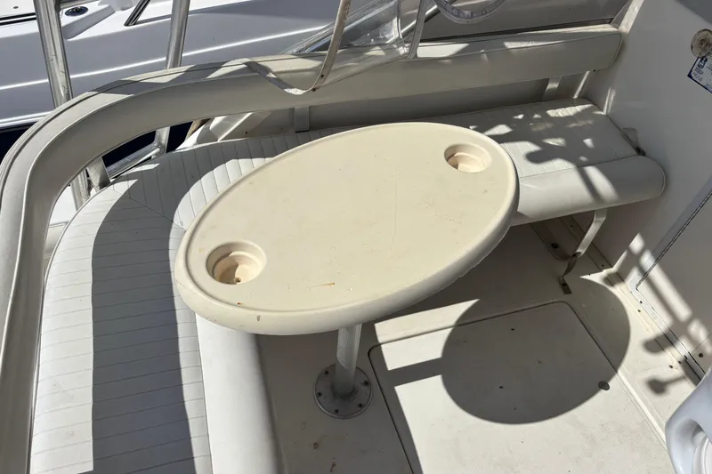 Slide: The Image of Interior seating area of a 2000 Shamrock 260 Express boat with oval table. - 43