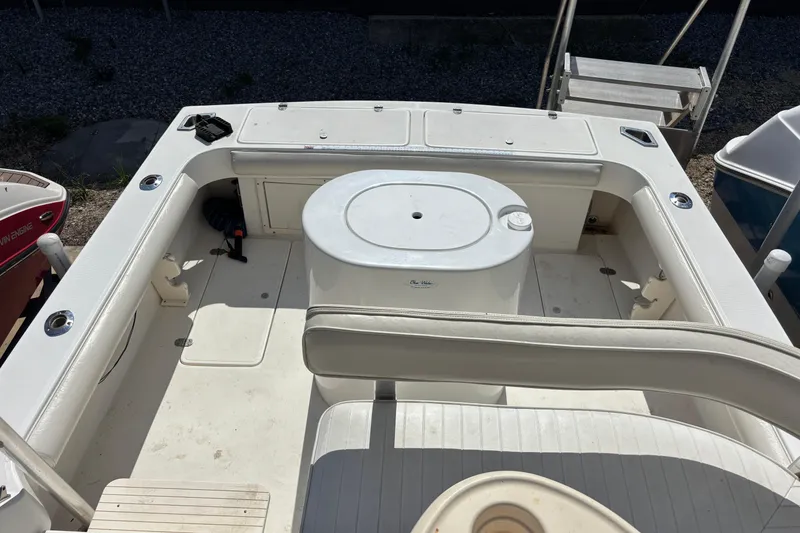 Slide: The Image of 2000 Shamrock 260 Express boat interior with seating and storage compartments. - 46