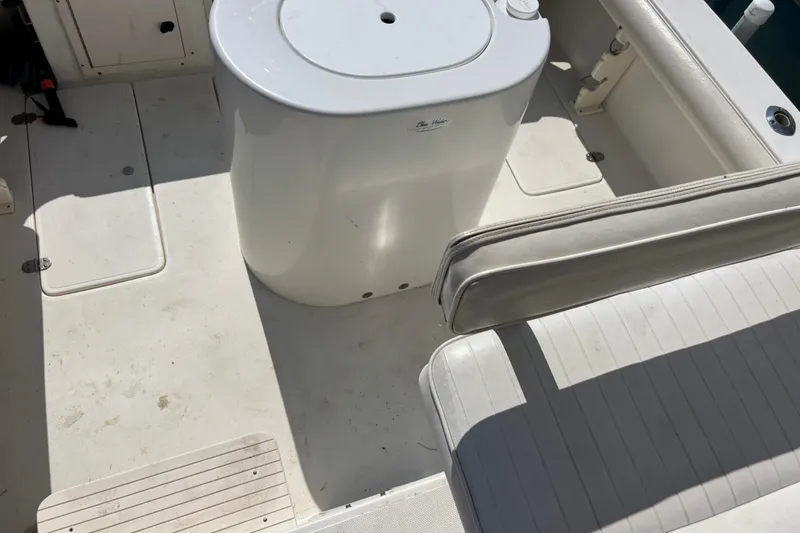 Slide: The Image of 2000 Shamrock 260 Express boat interior with seating and storage compartments. - 48