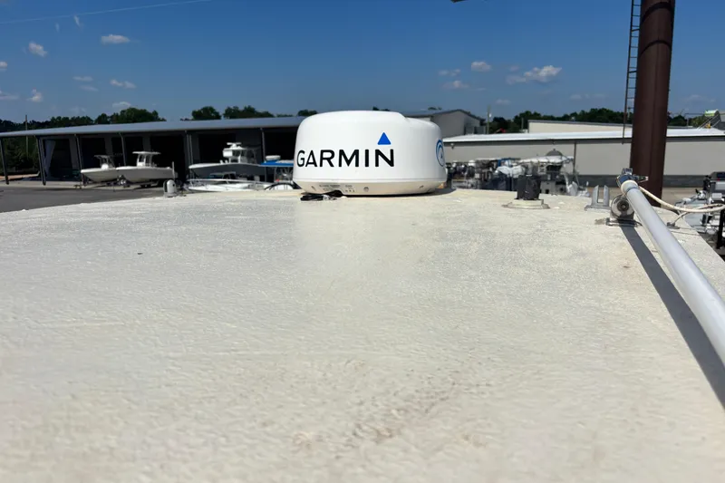 Slide: The Image of Rooftop view of 2000 Shamrock 260 Express with Garmin radar, boats in background. - 49