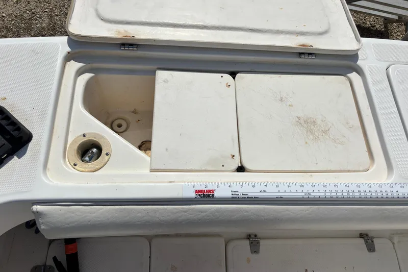 Slide: The Image of Shamrock 260 Express 2000 boat deck with storage compartments and measuring ruler. - 50