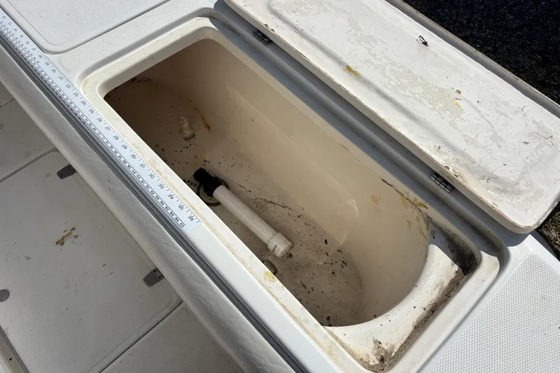 Slide: The Image of Open storage compartment on 2000 Shamrock 260 Express boat with measuring scale. - 51