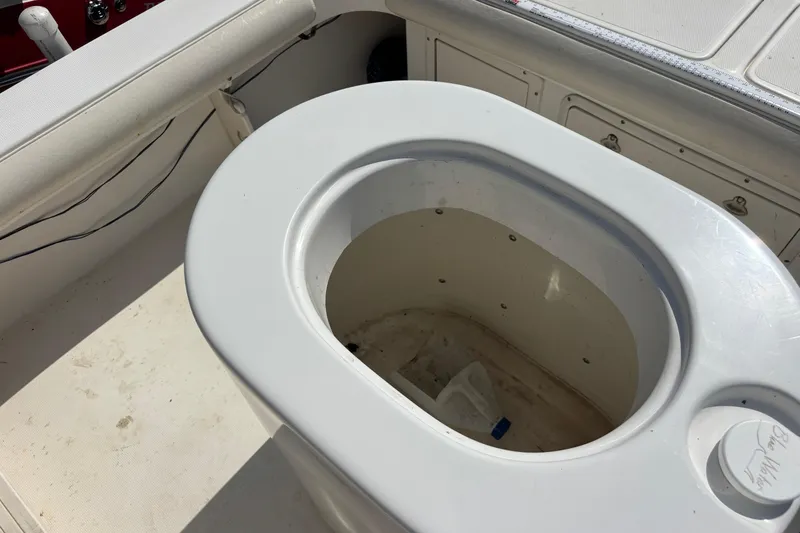 Slide: The Image of Livewell on 2000 Shamrock 260 Express boat, featuring white interior and storage compartments. - 52