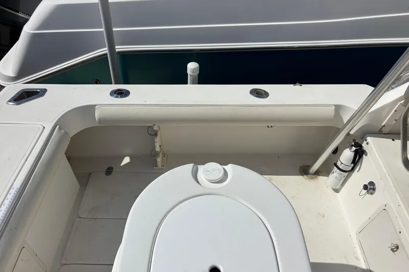 Slide: The Image of 2000 Shamrock 260 Express boat deck with seating and safety equipment. - 55