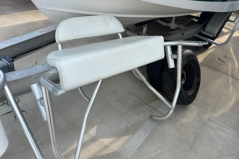 Slide: The Image of Boat trailer with seating, Shamrock 260 Express, 2000 model, parked on concrete surface. - 61