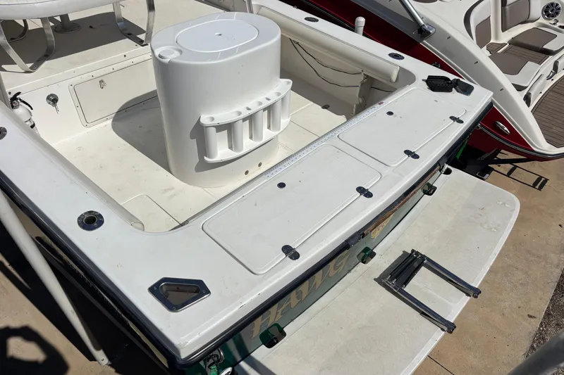 Slide: The Image of 2000 Shamrock 260 Express boat deck with storage compartments and seating area. - 7