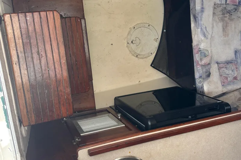 Slide: The Image of Interior of a 2000 Shamrock 260 Express boat with wooden and fabric details. - 9