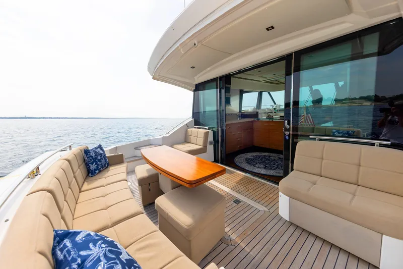 Slide: The Image of Luxurious 2014 Tiara 5000 Coupe yacht with elegant outdoor seating and ocean view. - 10