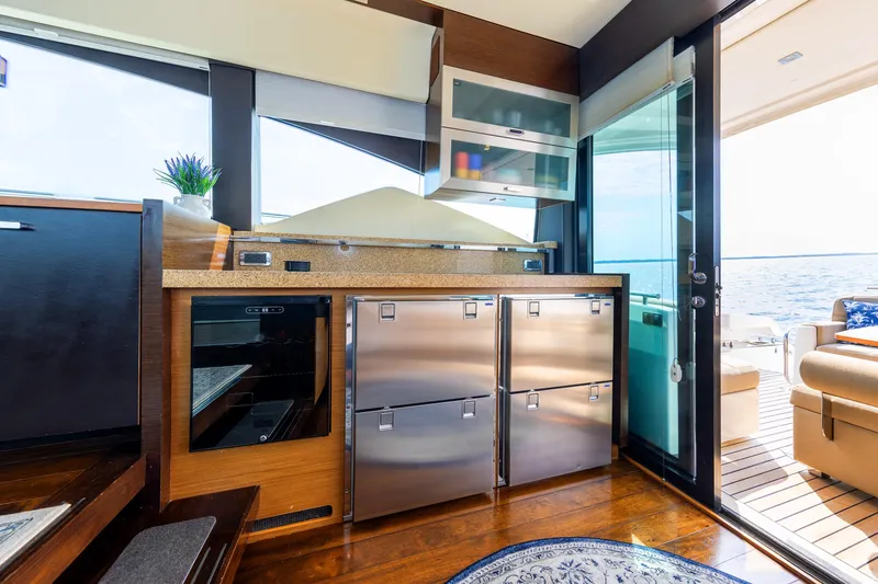 Slide: The Image of Luxurious interior of a 2014 Tiara 5000 Coupe yacht with modern kitchen and ocean view. - 14