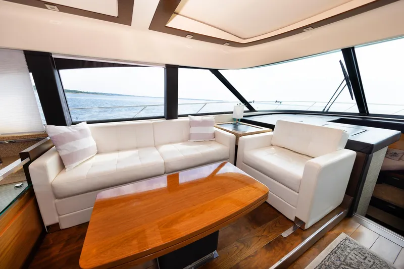 Slide: The Image of Luxurious interior of 2014 Tiara 5000 Coupe yacht with white seating and wooden table. - 19