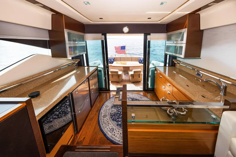 Slide: The Image of Luxurious interior of 2014 Tiara 5000 Coupe yacht with elegant wood finishes and ocean view. - 2