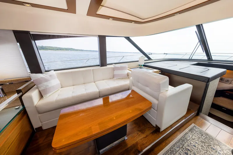 Slide: The Image of Luxurious interior of 2014 Tiara 5000 Coupe yacht with white seating and wooden table. - 20