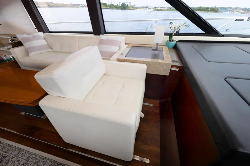 Slide: The Image of Luxurious interior of 2014 Tiara 5000 Coupe yacht with white seating and wooden accents. - 23