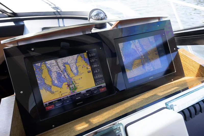 Slide: The Image of Navigation screens on a 2014 Tiara 5000 Coupe boat, displaying detailed marine maps. - 27