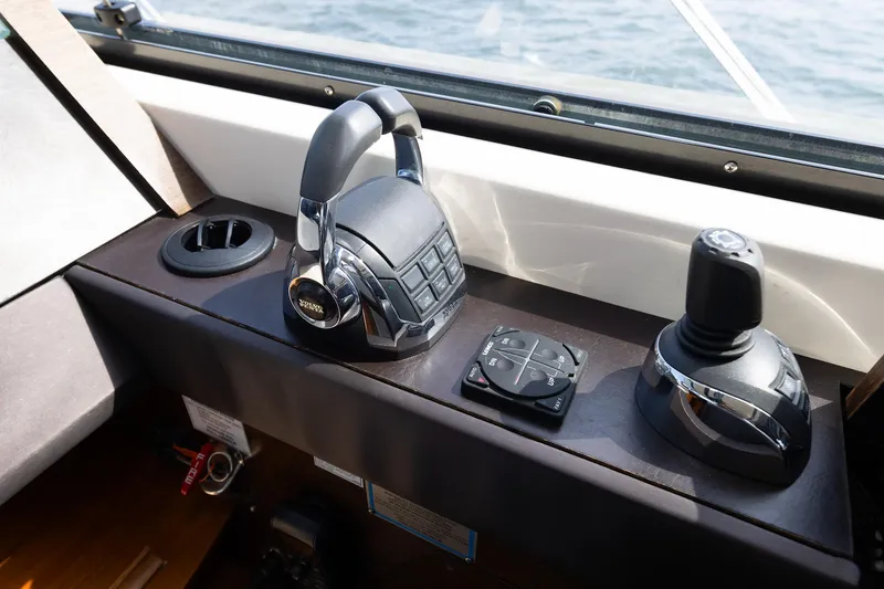 Slide: The Image of Control panel of a 2014 Tiara 5000 Coupe boat with joystick and throttle. - 28