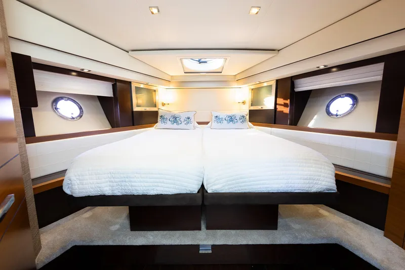 Slide: The Image of Luxurious bedroom interior of 2014 Tiara 5000 Coupe yacht with twin beds and portholes. - 32