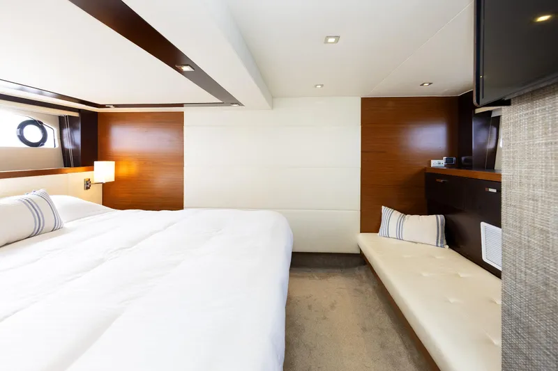 Slide: The Image of Luxurious interior of 2014 Tiara 5000 Coupe yacht with elegant wood paneling and plush bedding. - 36