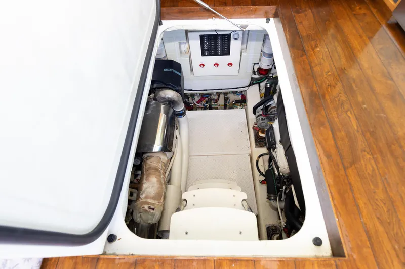 Slide: The Image of Engine compartment of a 2014 Tiara 5000 Coupe with visible components and wooden flooring. - 39
