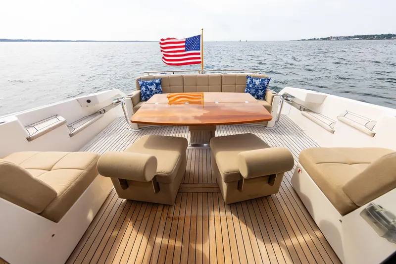 Slide: The Image of Luxurious 2014 Tiara 5000 Coupe yacht deck with seating, table, and American flag. - 5