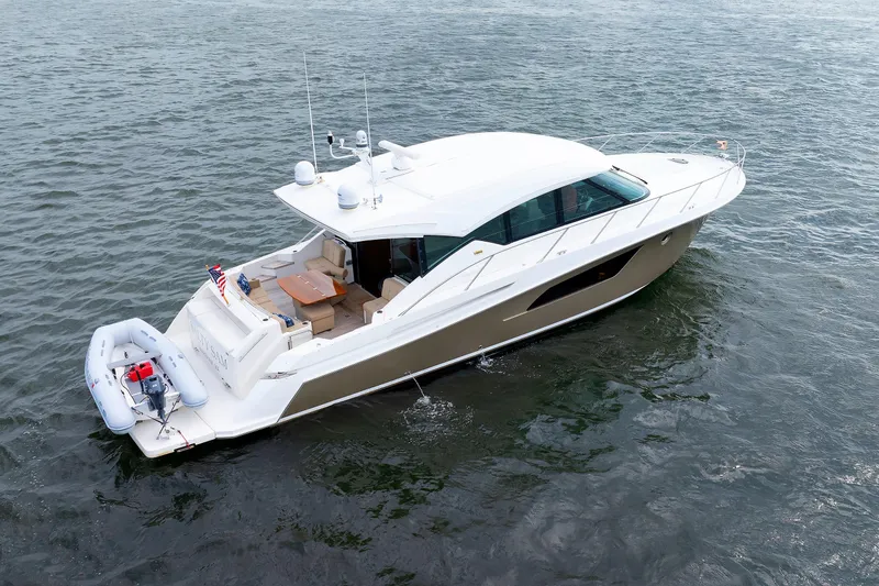 Slide: The Image of 2014 Tiara 5000 Coupe yacht on water, featuring sleek design and spacious deck. - 50