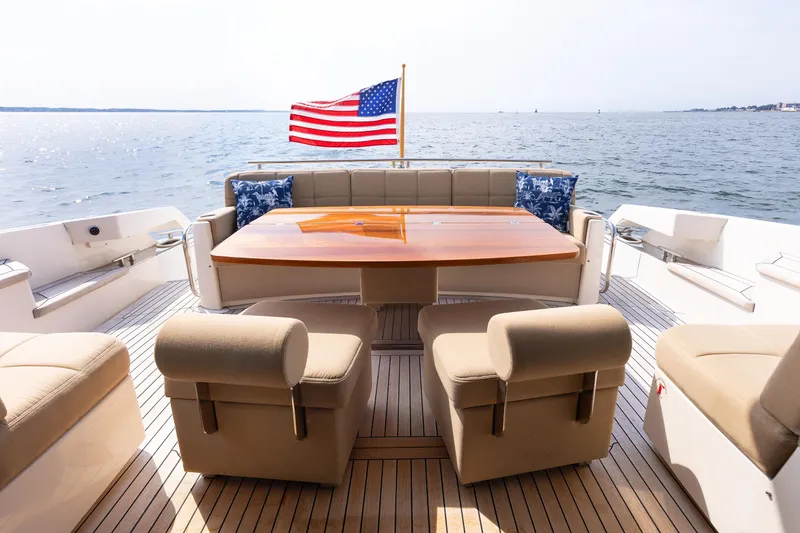 Slide: The Image of Luxurious 2014 Tiara 5000 Coupe yacht deck with seating, table, and American flag. - 7