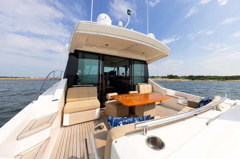 Slide: The Image of 2014 Tiara 5000 Coupe yacht with spacious deck and seating on open water. - 8