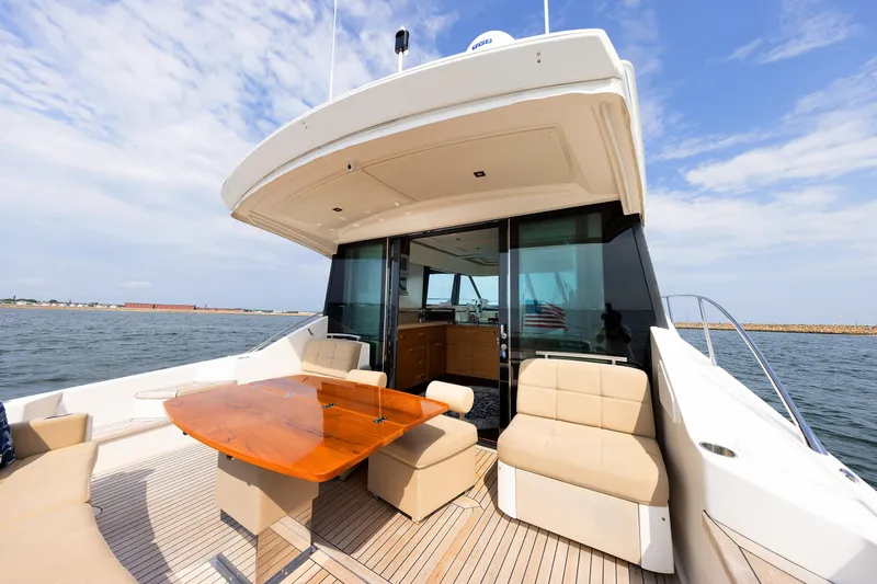Slide: The Image of Luxurious 2014 Tiara 5000 Coupe yacht with elegant outdoor seating and ocean view. - 9