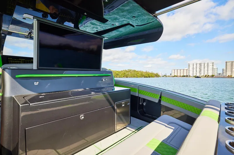 Slide: The Image of Luxury interior of Midnight Express 52' Vitesse boat with TV, overlooking waterfront cityscape. - 16