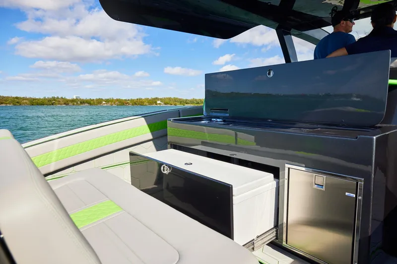 Slide: The Image of Luxury seating and amenities on a Midnight Express 52' Vitesse boat, cruising on a sunny day. - 17