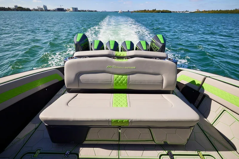 Slide: The Image of Luxury Midnight Express 52' Vitesse boat with sleek seating and powerful engines cruising on open water. - 19