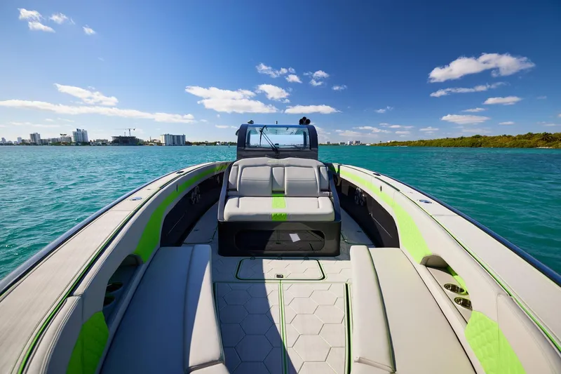 Slide: The Image of Midnight Express 52' Vitesse boat on turquoise water under clear blue sky. - 7