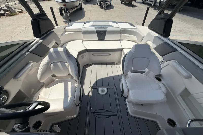 Slide: The Image of 2021 Chaparral 230 SSi boat interior with white seating and modern design. - 12