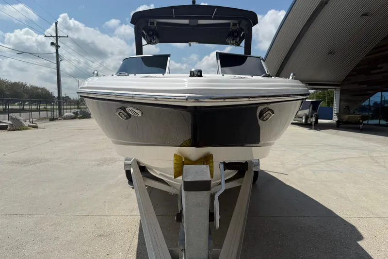 Slide: The Image of 2021 Chaparral 230 SSi boat on trailer, outdoor display, sunny day. - 3