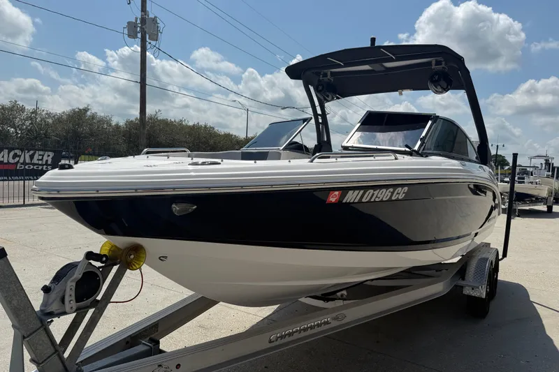 Slide: The Image of 2021 Chaparral 230 SSi boat on trailer under clear sky. - 4