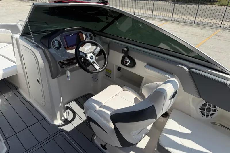 Slide: The Image of 2021 Chaparral 230 SSi boat cockpit with modern steering and dashboard controls. - 9