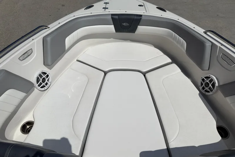 Slide: The Image of 2021 Chaparral 230 SSi boat interior with cushioned seating and built-in speakers. - 11
