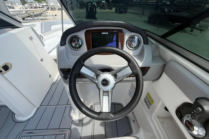 Slide: The Image of 2021 Chaparral 230 SSi boat dashboard with steering wheel and gauges. - 16