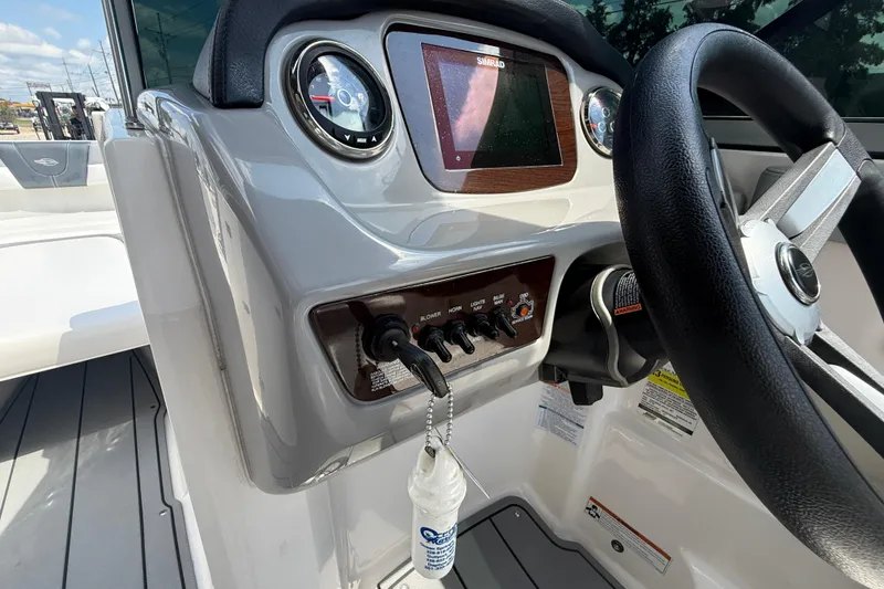Slide: The Image of 2021 Chaparral 230 SSi boat dashboard with steering wheel and control panel. - 17