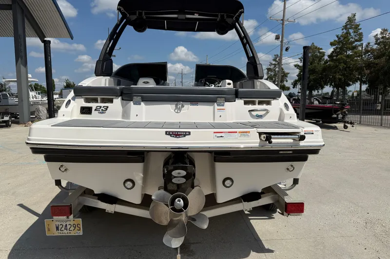 Slide: The Image of 2021 Chaparral 230 SSi boat rear view with propeller, parked outdoors. - 6