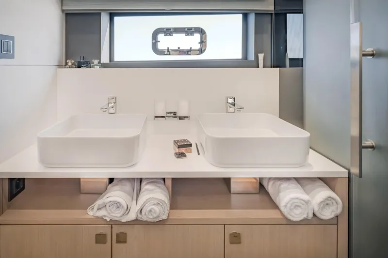Slide: The Image of Luxury yacht bathroom with dual sinks, modern fixtures, and rolled towels, Privilege Signature 650, 2025. - 35