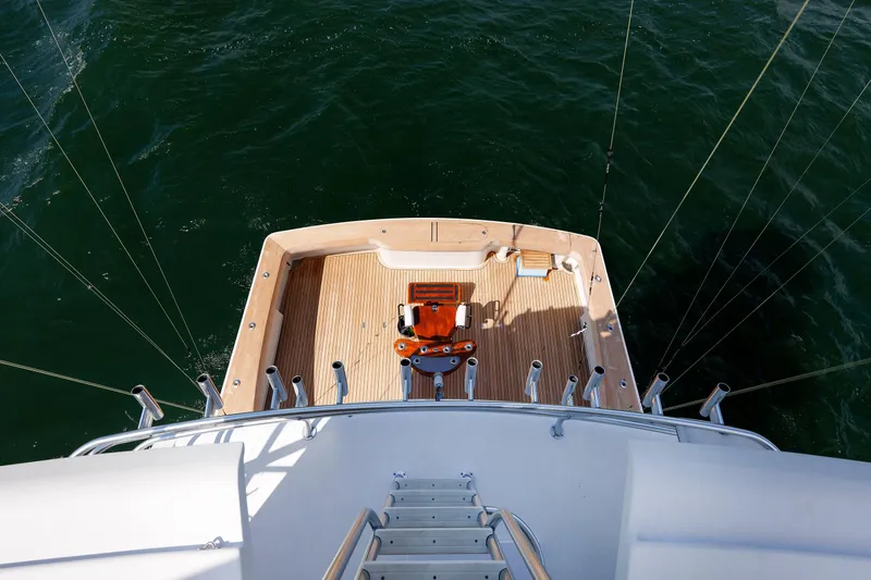 Slide: The Image of 2009 Viking 74 Enclosed Bridge yacht deck with fishing chair, surrounded by ocean. - 104