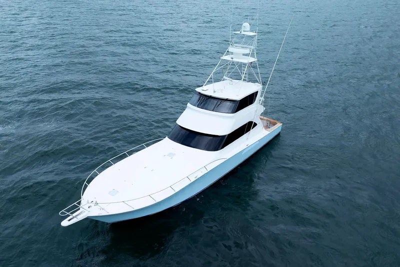 Slide: The Image of 2009 Viking 74 Enclosed Bridge yacht cruising on open water. - 14