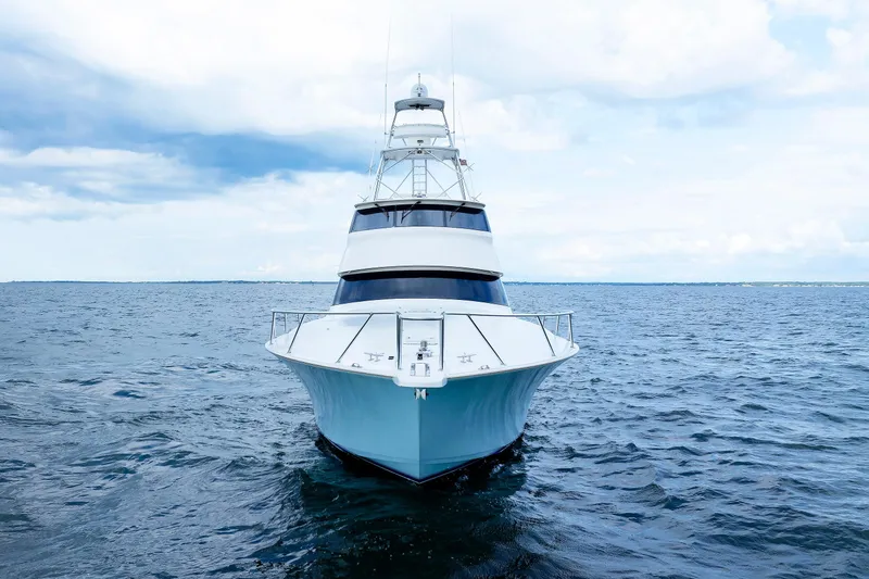Slide: The Image of 2009 Viking 74 Enclosed Bridge yacht on open sea, front view. - 2