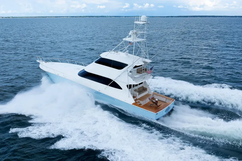 Slide: The Image of 2009 Viking 74 Enclosed Bridge yacht cruising on open water. - 29